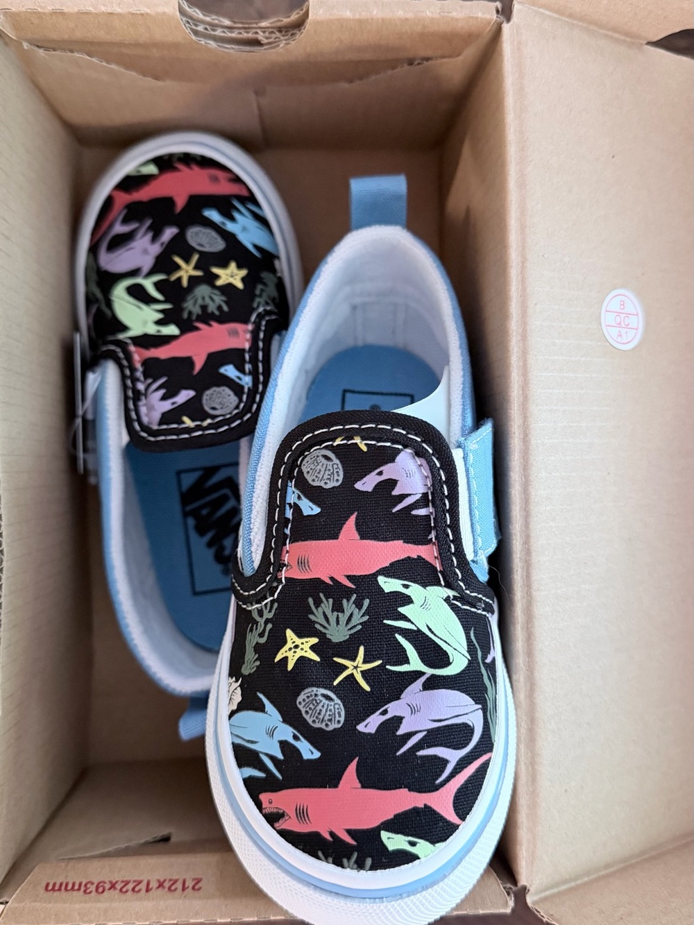 Vans Kids Slip-On Sneakers in Black with Pastel Shark Print